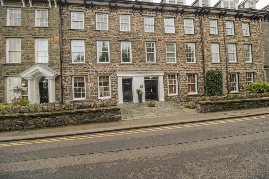 a large brick building with white doors and windows at Derwentwater Apartment in Keswick