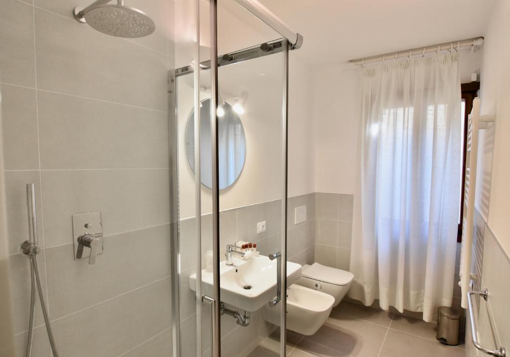 a bathroom with a toilet and a sink and a shower at Charming Venice Apartments in Venice