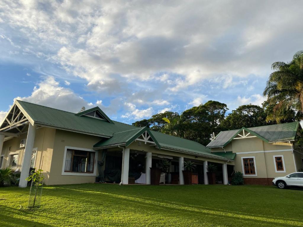 a house with a green roof on a yard at Waterloo Guest House in Durban