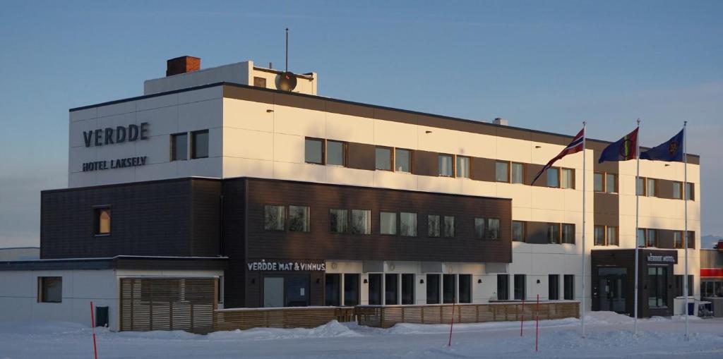 a building with two flags in front of it at Verdde Hotel Lakselv in Lakselv
