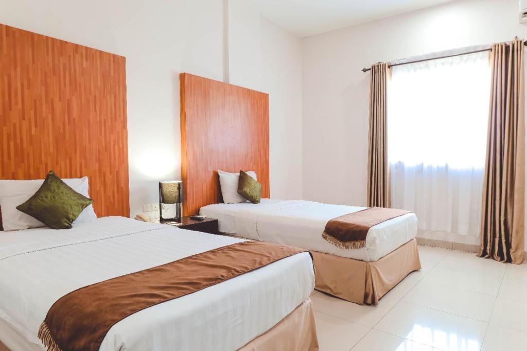 Postel nebo postele na pokoji v ubytování Saka Hotel Medan