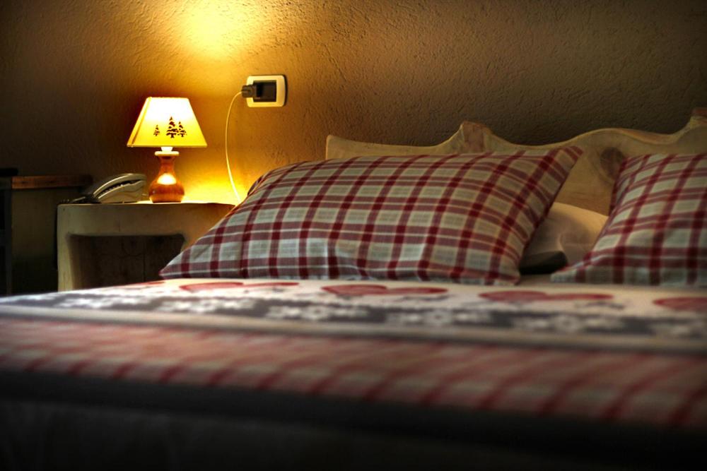 Postel nebo postele na pokoji v ubytování Hotel Tivet