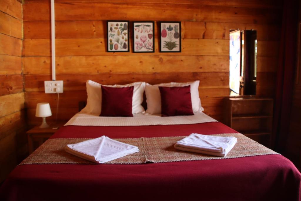 a bedroom with a bed with two towels on it at Cilantro Agonda in Agonda
