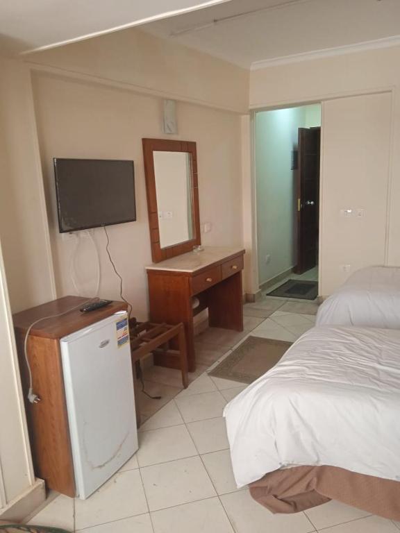 Postel nebo postele na pokoji v ubytování Regency Hotel