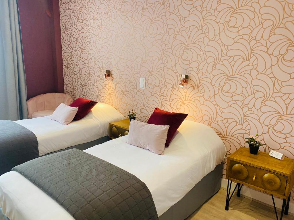 Postel nebo postele na pokoji v ubytování Grand Hôtel de L'Espérance