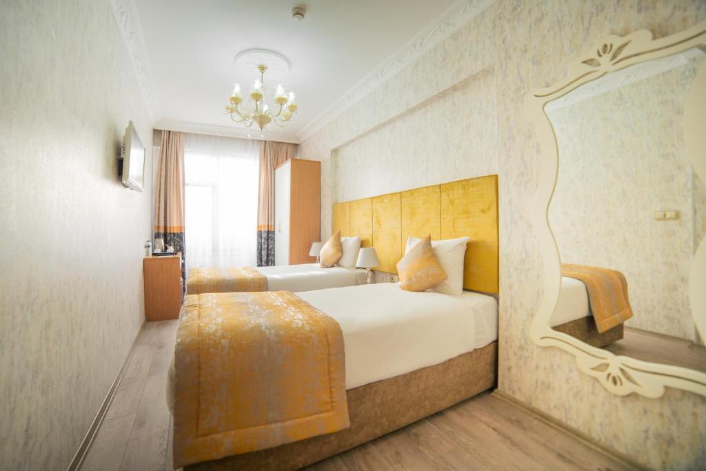 Postel nebo postele na pokoji v ubytování Miran Hotel