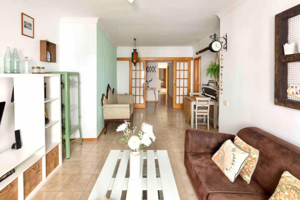 a living room with a couch and a table at Atlantic Flat - Acogedor piso en Vegueta, Las Palmas in Las Palmas de Gran Canaria