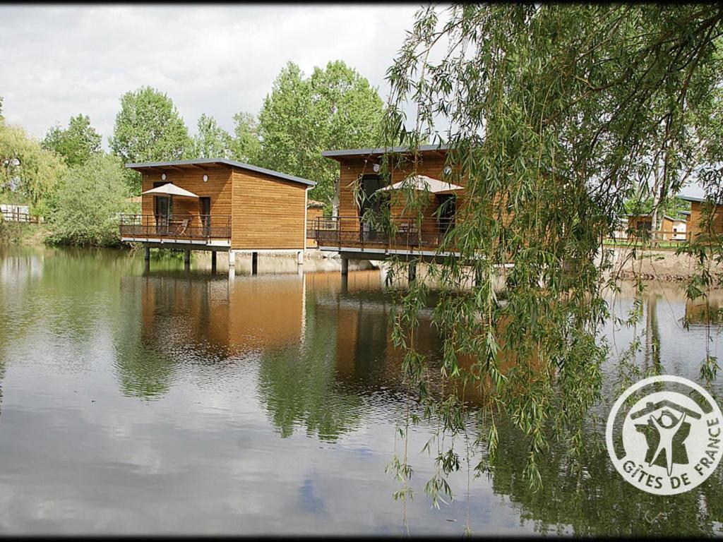 a couple of cottages sitting on top of a lake at Gîte Veauchette, 2 pièces, 2 personnes - FR-1-496-77 in Veauchette