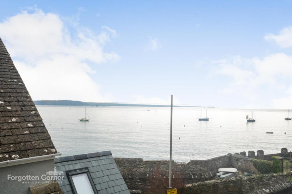 a view of a body of water with boats at Kelvin House - Cawsand in Cawsand