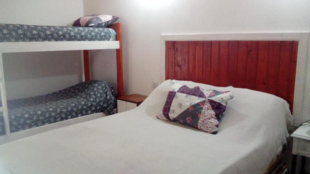 a bedroom with a bunk bed with a pillow on it at Las orquídeas in Goya