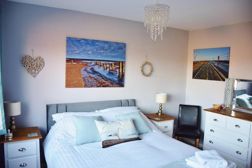 a bedroom with a bed and a chandelier at Abbey View Bagdale in the Centre of Whitby in Whitby