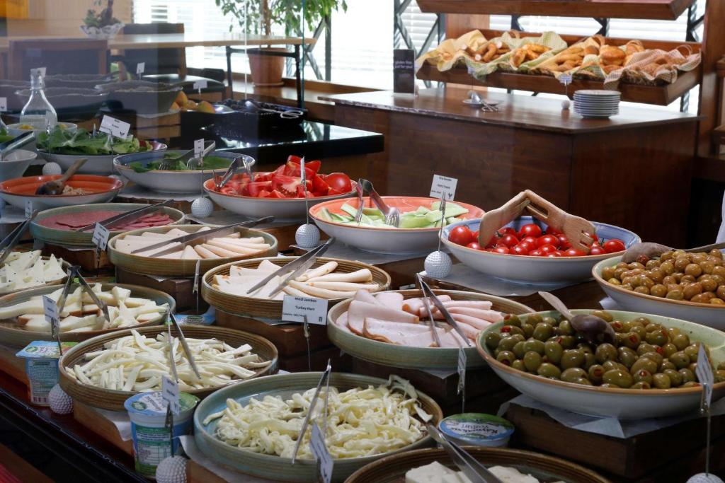 a buffet filled with different types of food in bowls at Park Inn by Radisson Istanbul Asia Kavacik in Istanbul