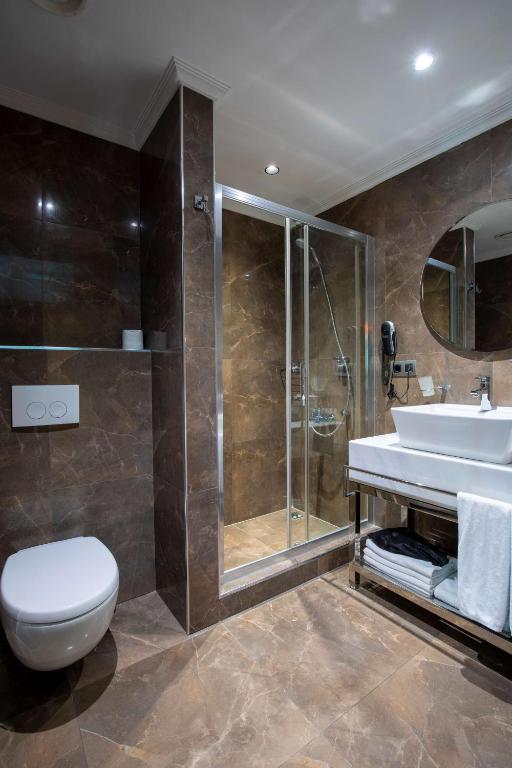a bathroom with a toilet and a sink and a shower at Park Inn by Radisson Istanbul Asia Kavacik in Istanbul