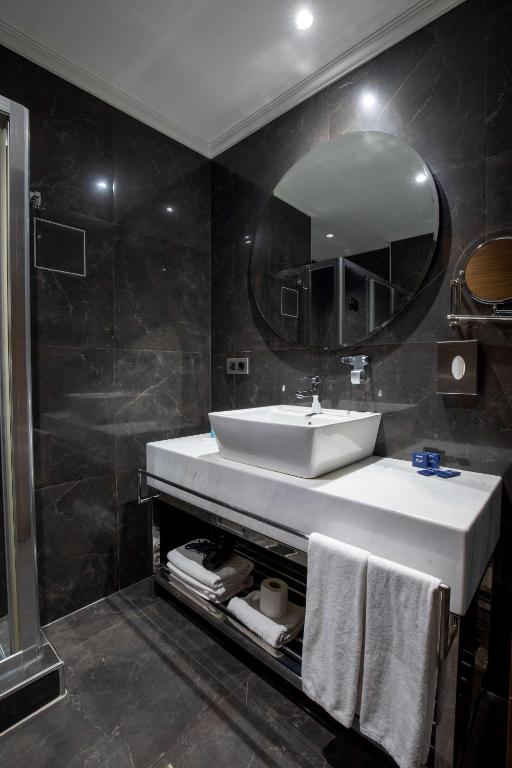 a bathroom with a sink and a mirror at Park Inn by Radisson Istanbul Asia Kavacik in Istanbul
