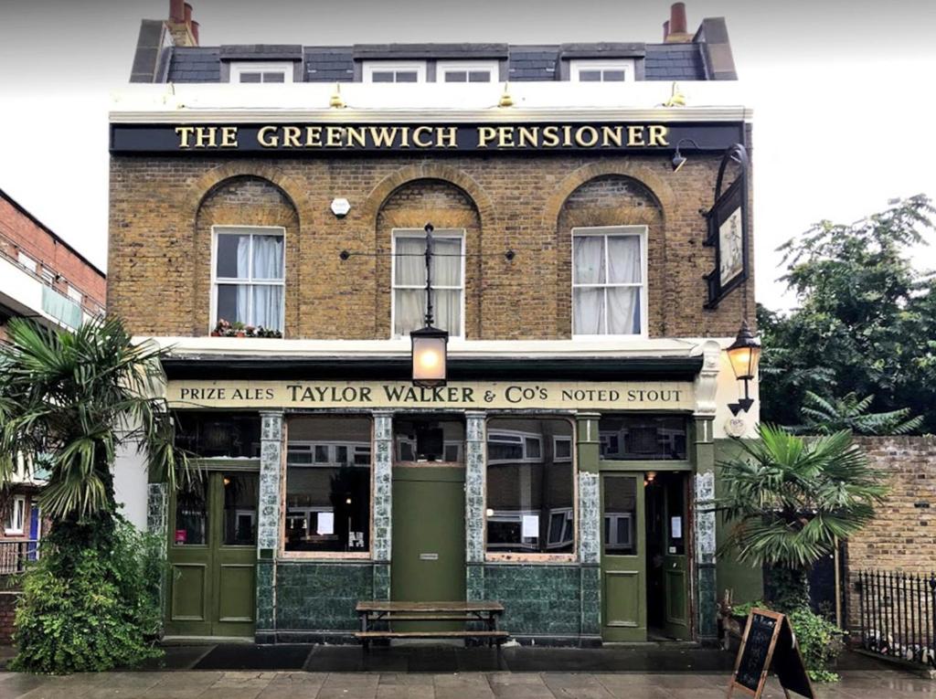 a brick building with a sign that reads the greenwich premier at The Greenwich Pensioner Guesthouse in London