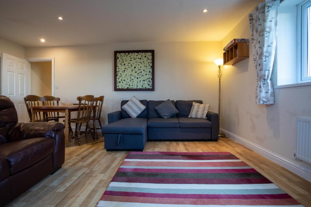a living room with a couch and a table at Denecroft apartments in Lynemouth