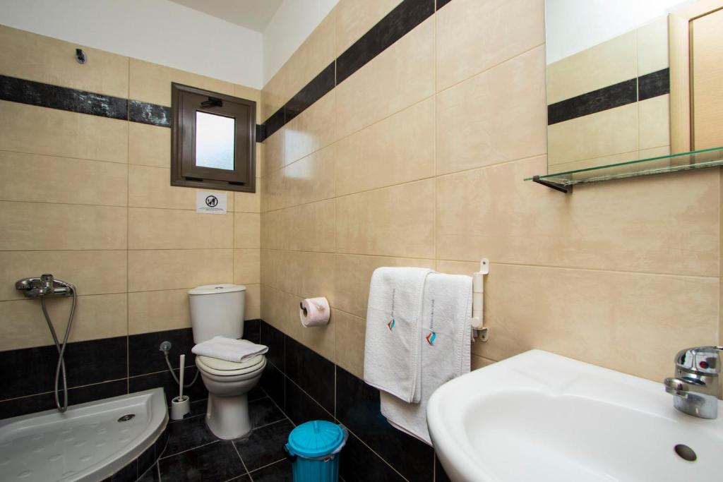 a bathroom with a toilet and a sink and a tub at Possidi Villas by Halkidiki Villas in Possidi