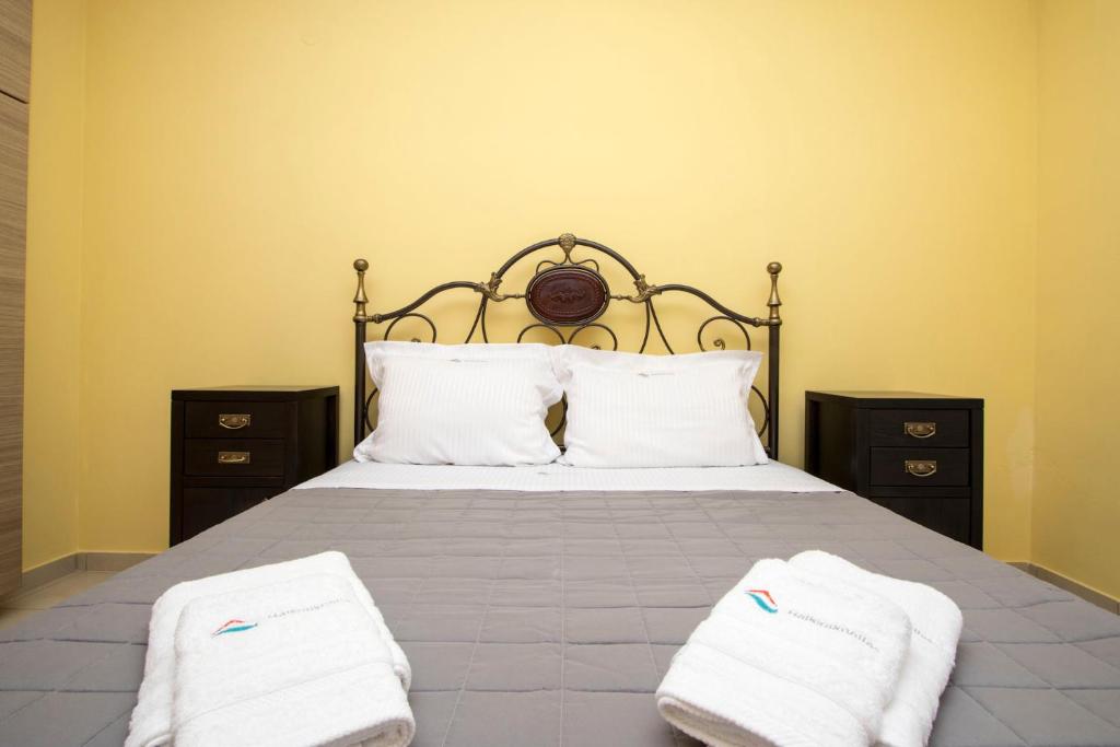 a bedroom with a bed with two towels on it at Possidi Villas by Halkidiki Villas in Possidi