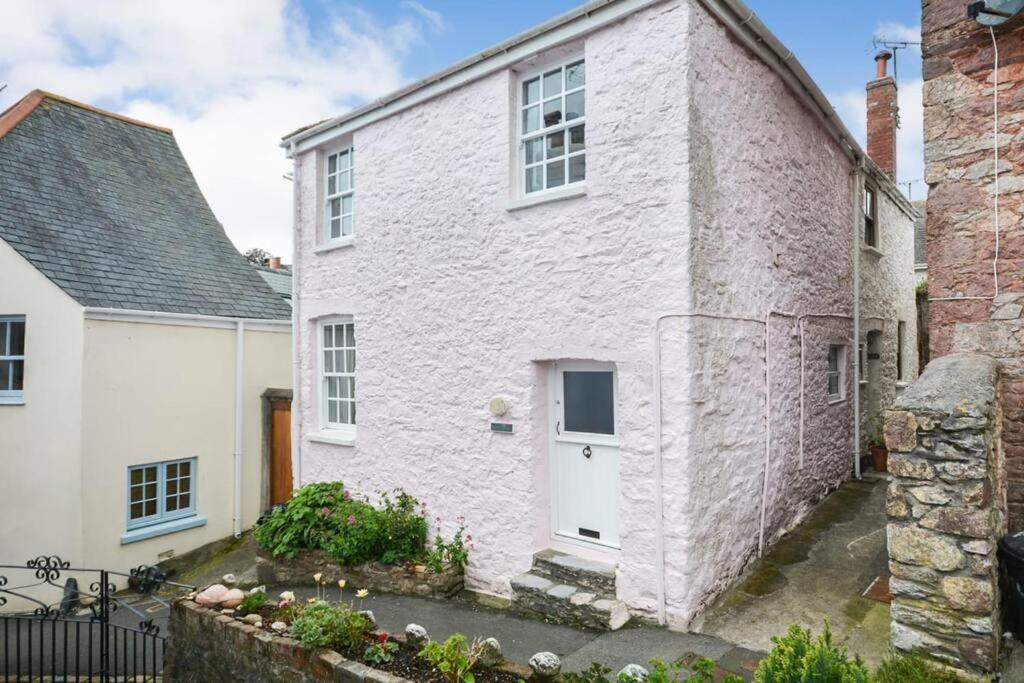 a white house with a white door and a brick building at Rose Cottage - Kingsand in Kingsand