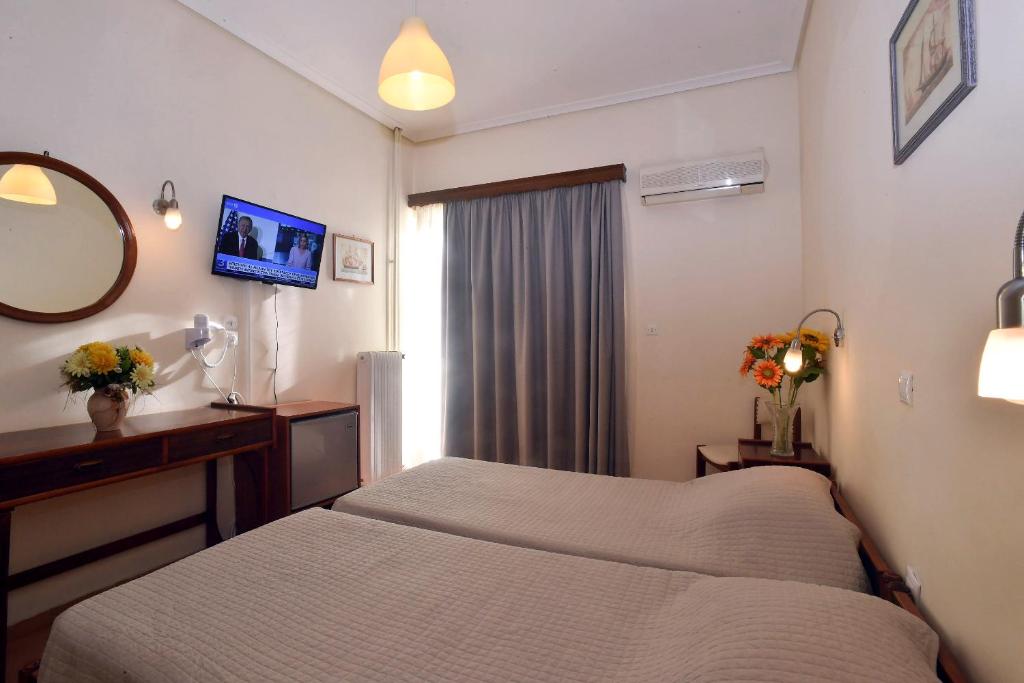 A bed or beds in a room at Siagas Beach Hotel