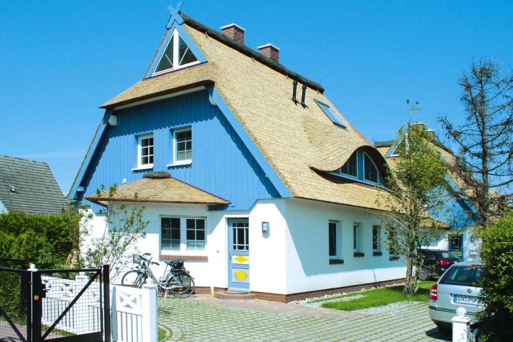 a blue and white house with a roof at Semi-detached house, Zingst in Zingst