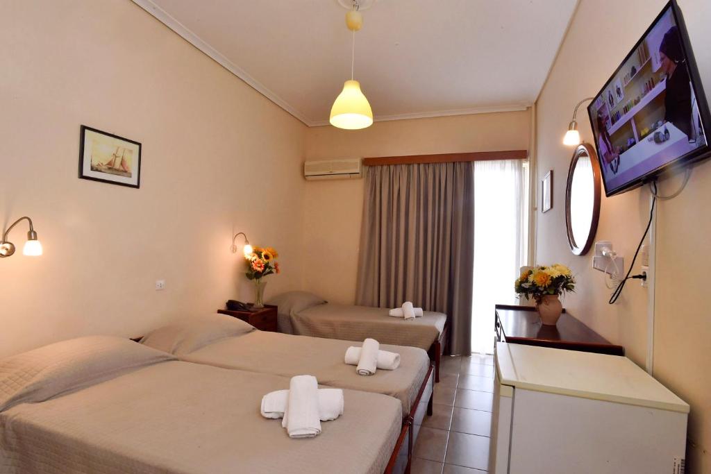 A bed or beds in a room at Siagas Beach Hotel