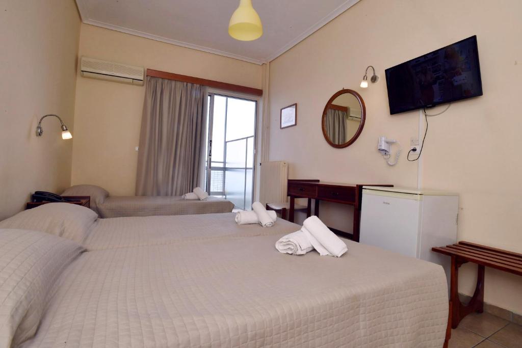 A bed or beds in a room at Siagas Beach Hotel