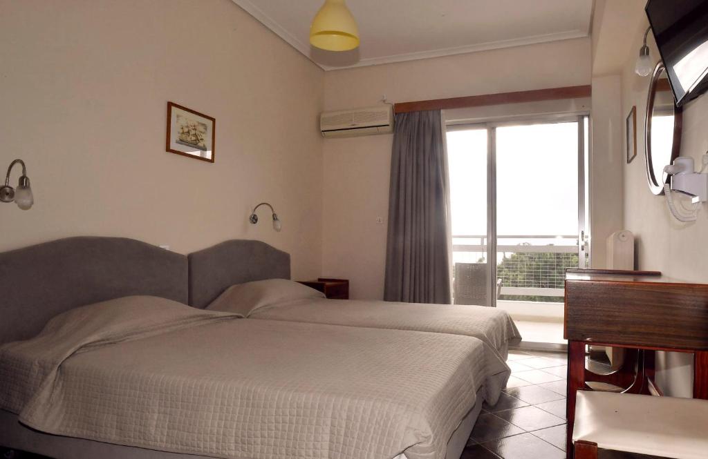 A bed or beds in a room at Siagas Beach Hotel