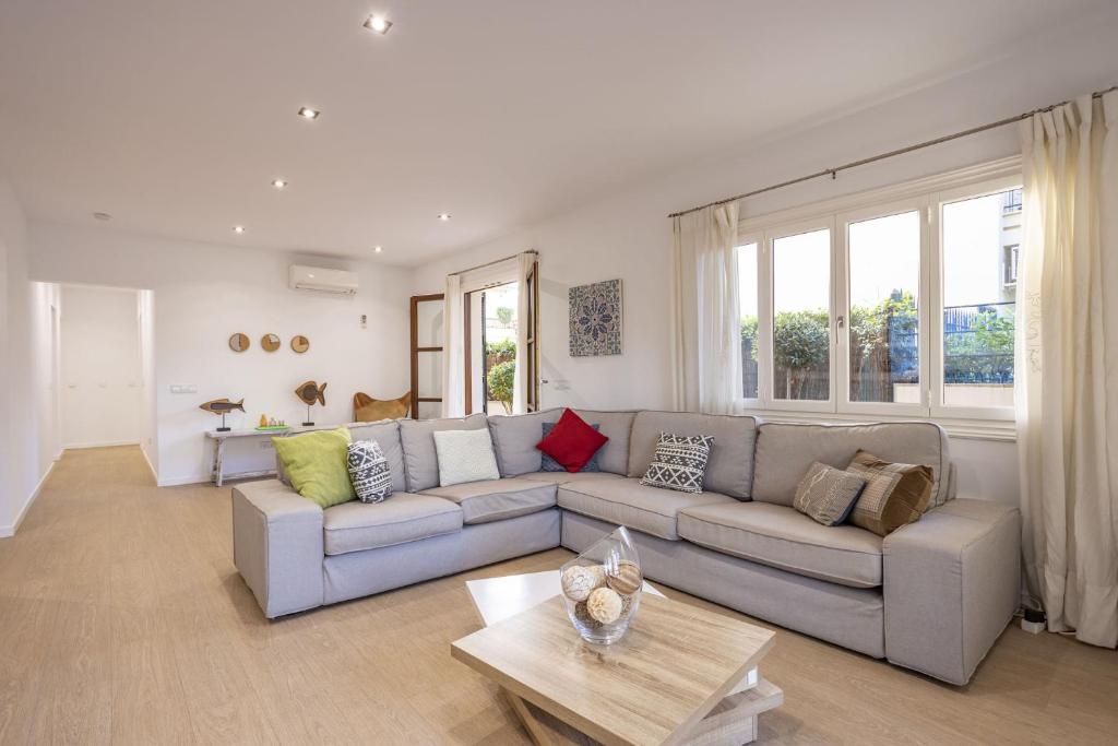 a living room with a couch and a table at House Can Toni in Port d'Alcudia