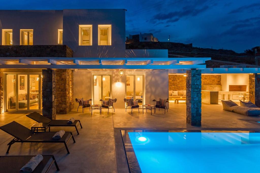 a villa with a swimming pool at night at Anarina Villas & Suites Elia Beach in Mýkonos City
