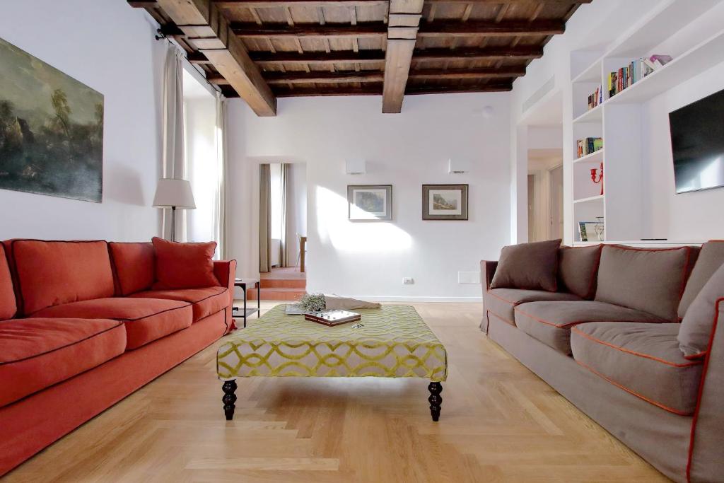a living room with red couches and a coffee table at Residenza Torre Vecchiarelli - apt 3 in Rome