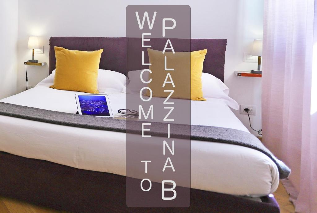 a bedroom with a bed with a laptop on it at Palazzina B - Contemporary Studio in Genoa