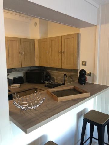 a kitchen with a sink and a counter top at Hôtel Beau Rivage in Royan