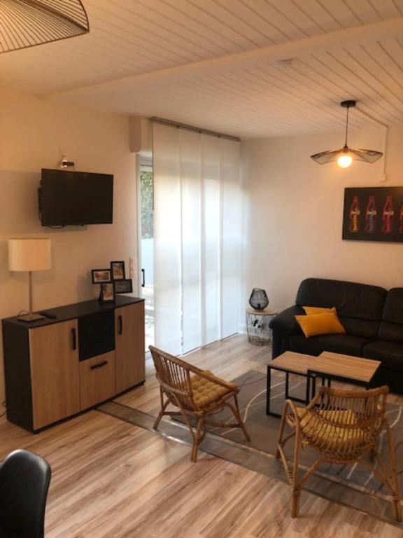 a living room with a couch and a table at Hôtel Beau Rivage in Royan