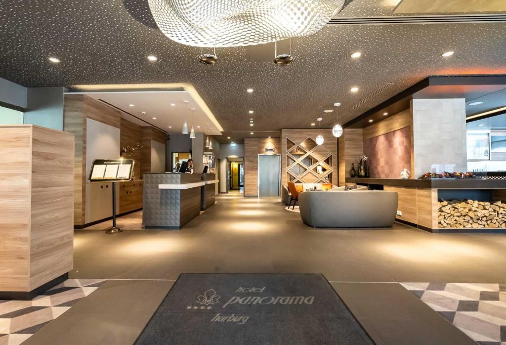 a lobby of a wine store with a couch and a table at Hotel Panorama Hamburg-Harburg in Hamburg