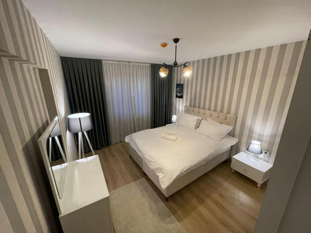 a bedroom with a white bed and two tables at King Suite SS0 in Istanbul