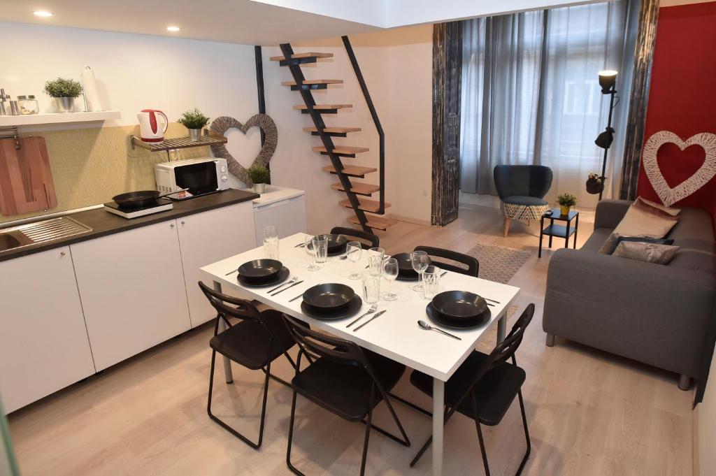 a kitchen and a dining room with a table and chairs at The APEX Residences in Budapest