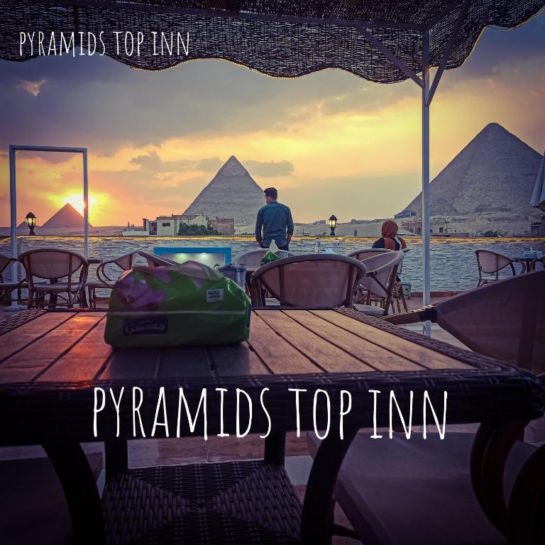 a group of people sitting at a table with the pyramids top inn at Pyramids Top Inn in Cairo