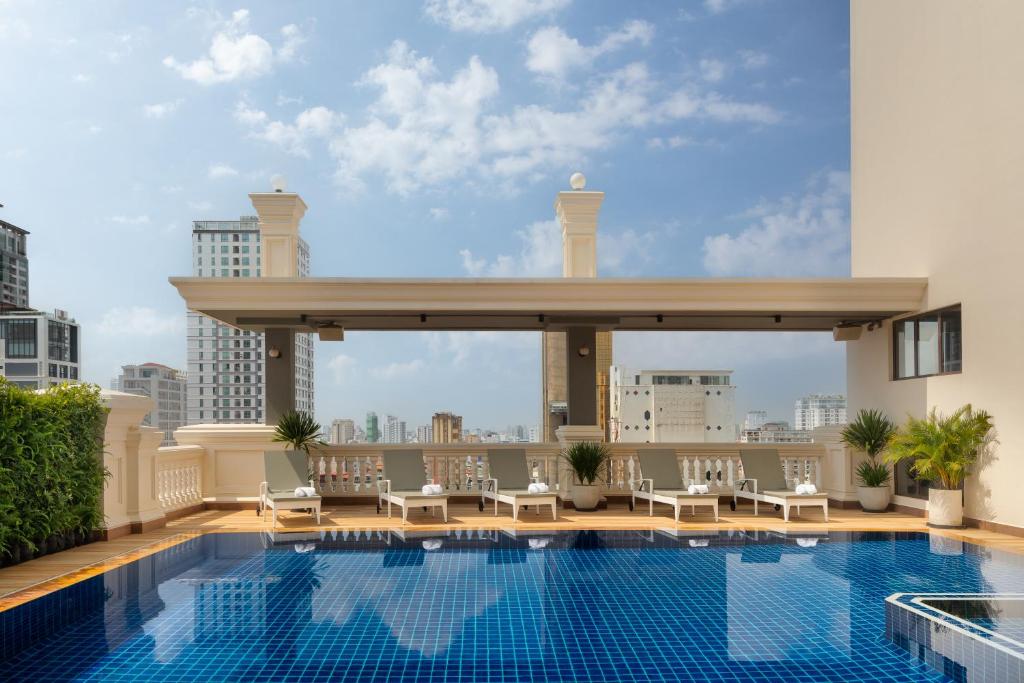 a swimming pool on the roof of a building with a view at Duong Chan Hotel in Phnom Penh