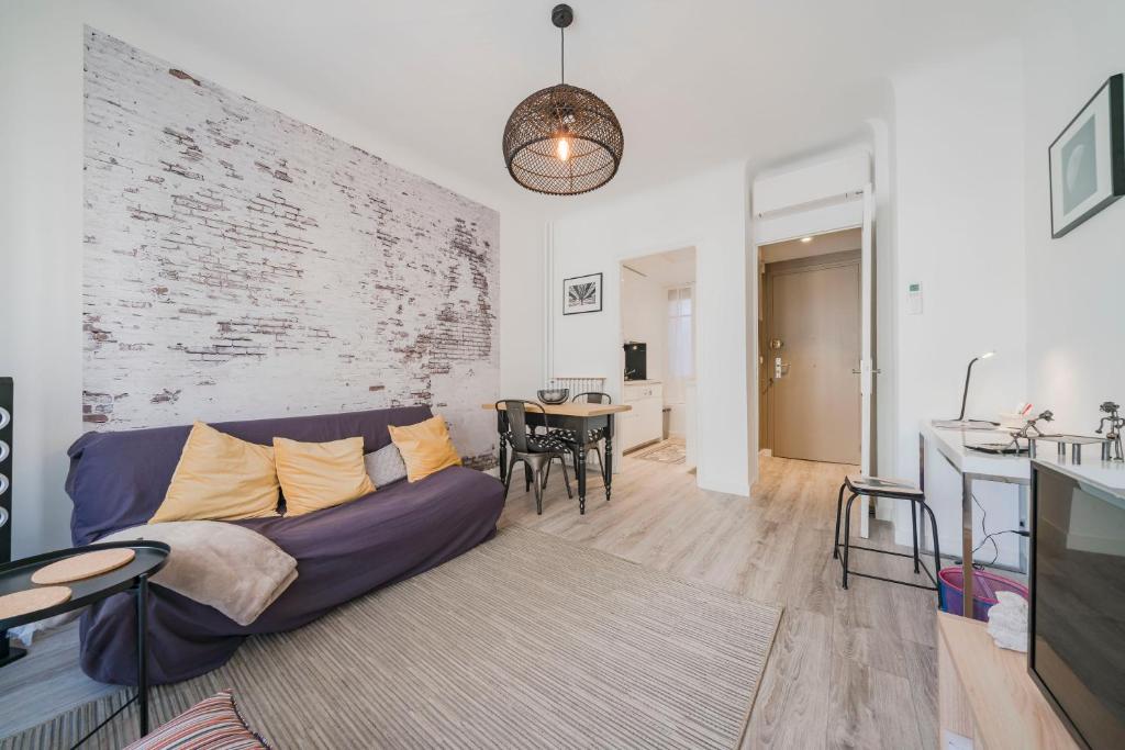 a living room with a couch and a table at Brand new one bedroom heart of Cannes!! in Cannes