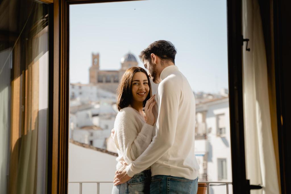 a man and a woman standing in front of a window at Hotel Abaco Altea in Altea