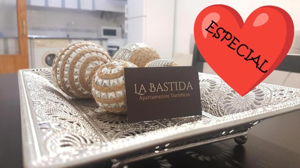 a tray with eggs and a red heart and a sign at Apartamentos la Bastida in Totana