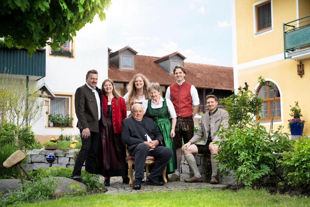 a group of people posing for a picture in front of a house at Hotel Preishof in Kirchham