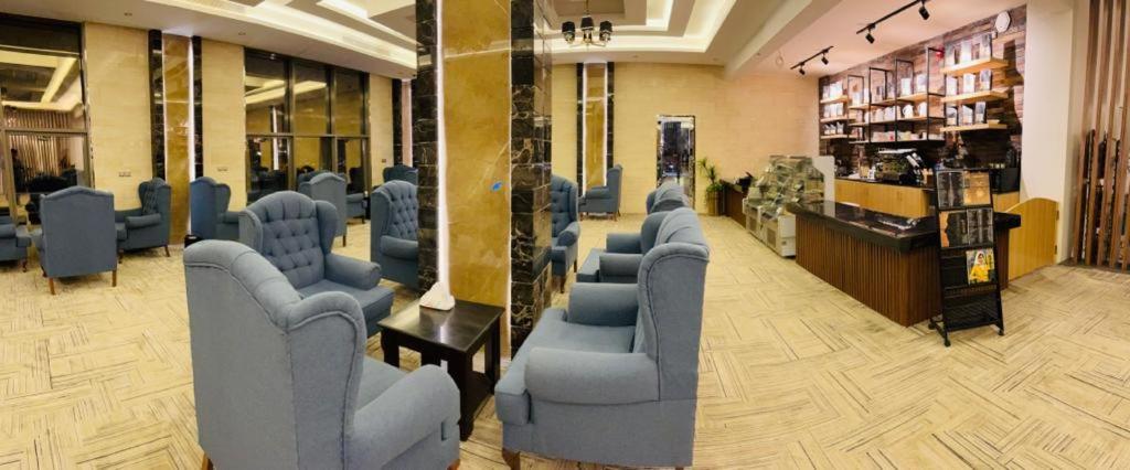 a waiting room with blue chairs in a store at فندق وريف الشرق in Sarat Abidah
