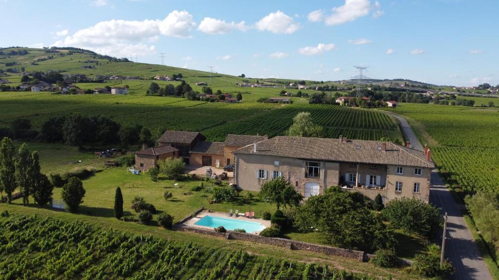 an aerial view of a house in the middle of a vineyard at Domaine David-Beaupère in Juliénas