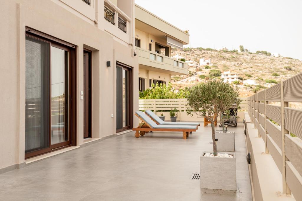 a balcony of a building with a bench on it at Thyme Sea View Apartments in Souda