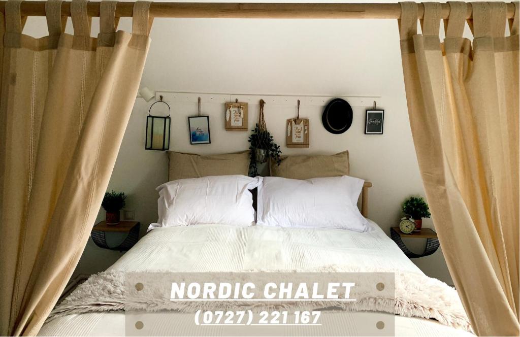 a bedroom with a bed with curtains in it at Nordic Chalet in Sinaia