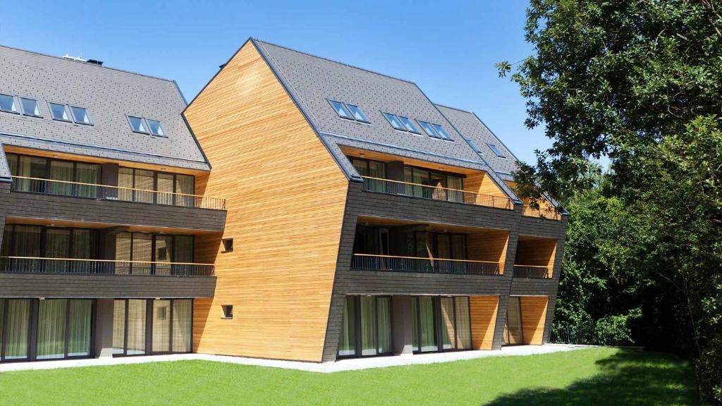 a large building with a wooden facade at APARTMA My HILL 5 in Maribor