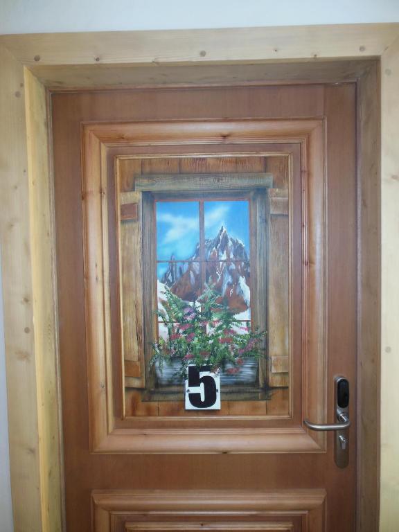 a sign on a door with a picture on it at Alpine Lodge 5 in Les Contamines-Montjoie