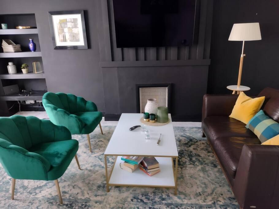 a living room with a couch and chairs and a table at White Birds Townhouse in Sligo Town Center in Sligo